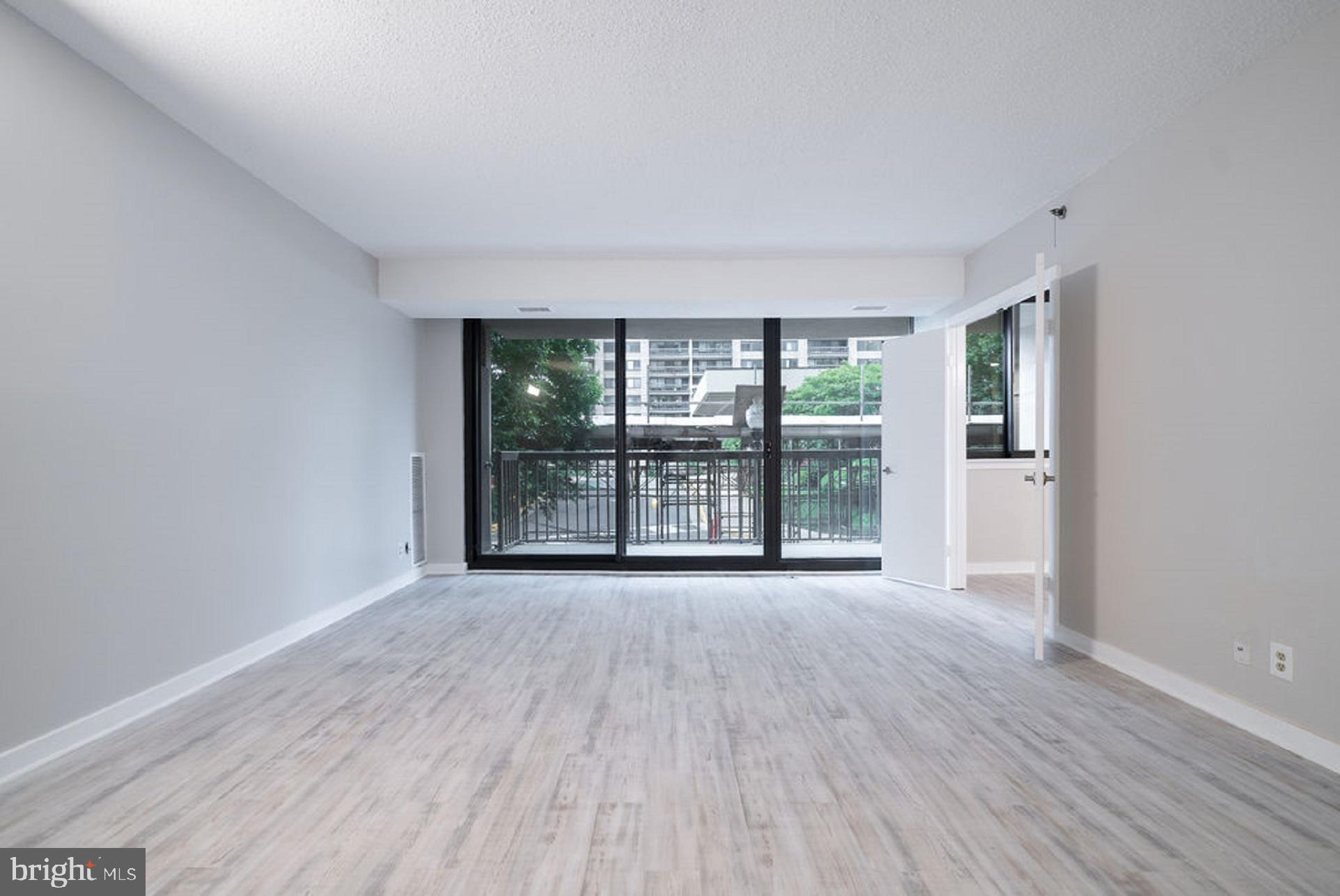 5505 Seminary Road, Unit 103N Falls Church, VA 22041 - Photo 2 of 59 a view of an empty room with wooden floor and a window