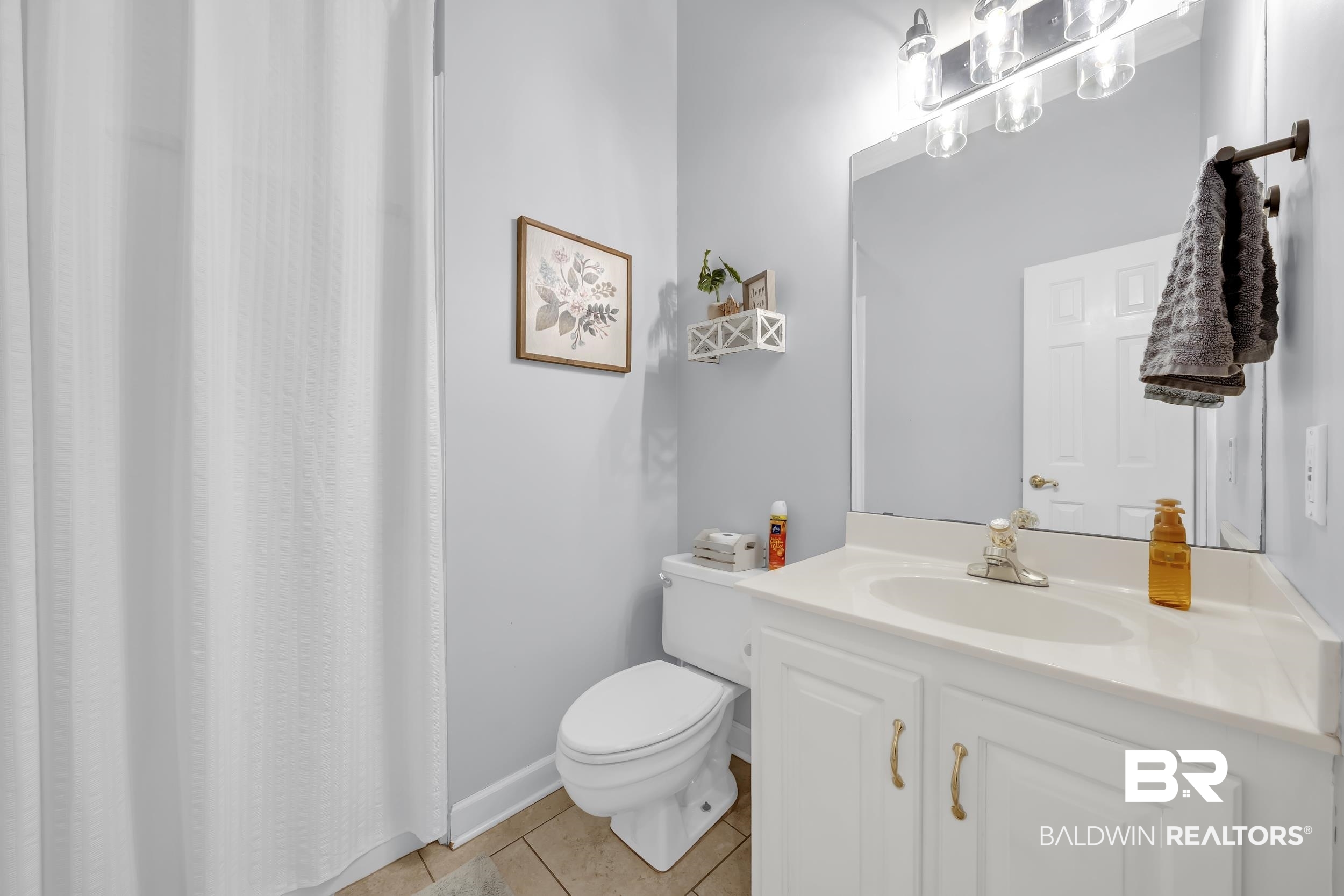 2858 Postoak Circle Mobile, AL 36693 - Photo 29 of 32 Bathroom with vanity, light tile patterned floors, and a shower with curtain