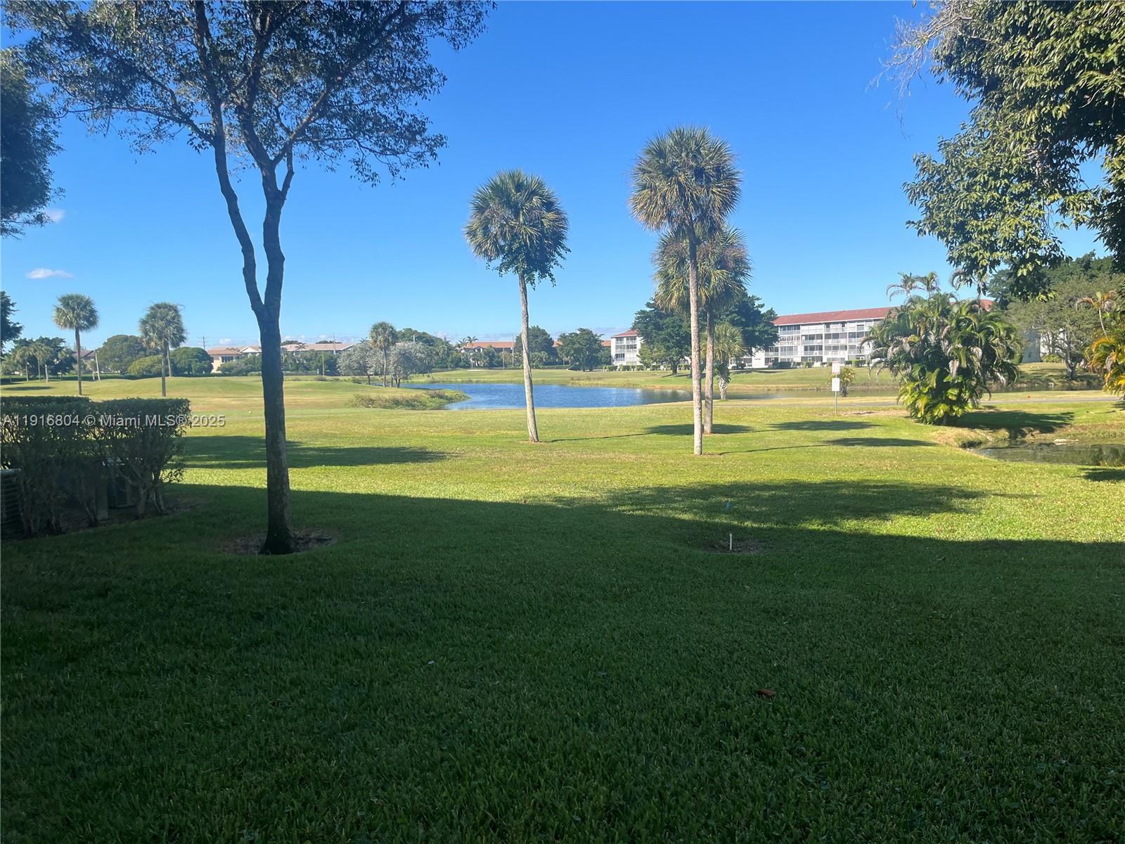 850 Southwest 133rd Terrace, Unit 206B Pembroke Pines, FL 33027 - Photo 1 of 9 a view of a park with large trees
