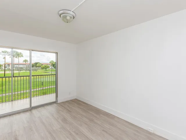 a view of a room with wooden floor and windows