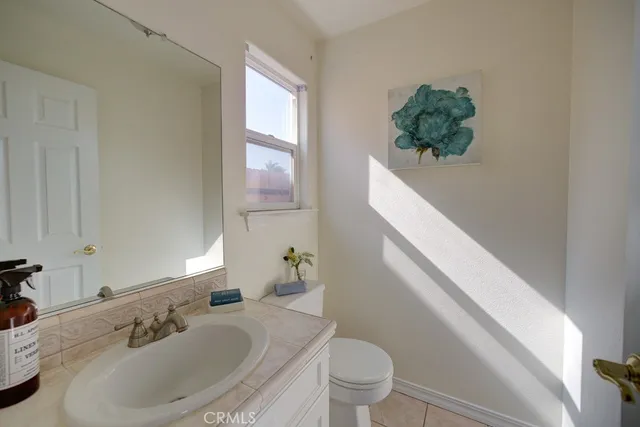 a bathroom with a sink toilet and mirror