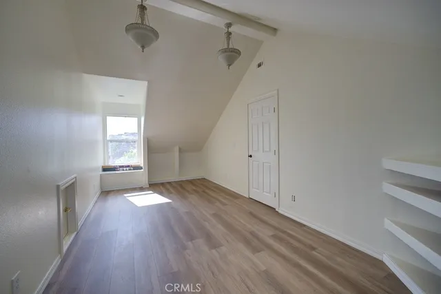 a view of a room with wooden floors and window