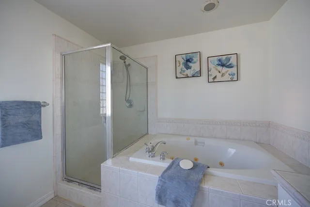 a bathroom with a tub a sink and mirror