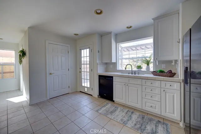 a spacious bathroom with a granite countertop sink and a mirror