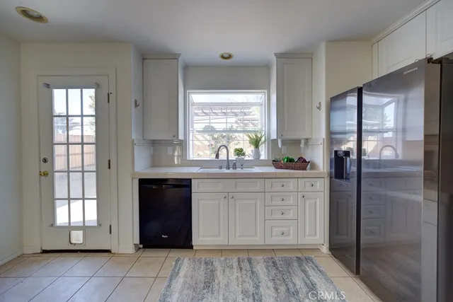 a large bathroom with a granite countertop sink and a window
