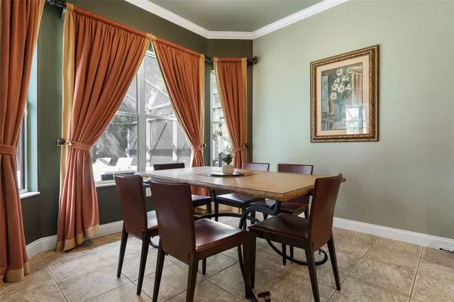 a dining room with furniture and a floor to ceiling window