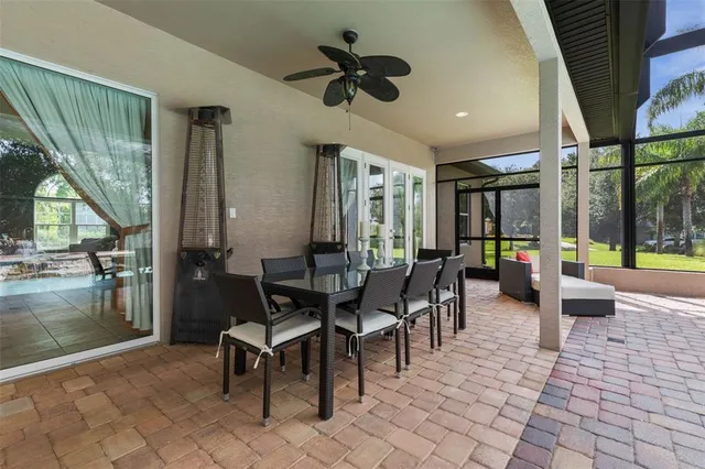 a view of a swimming pool with a patio and a yard