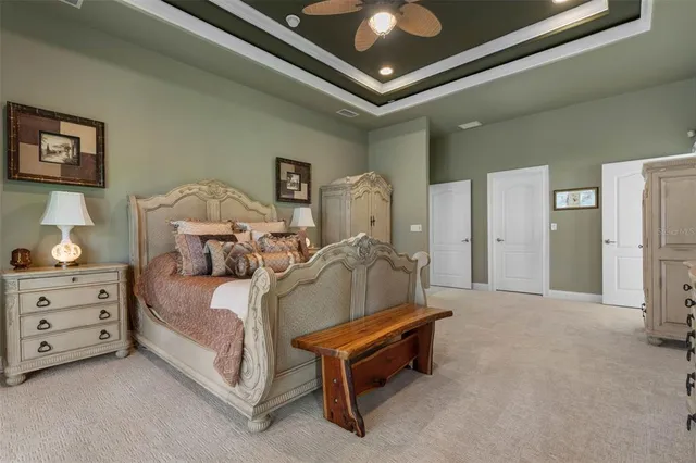 a spacious en suite bathroom with a double vanity sink a mirror and a