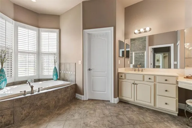 a bath tub sitting in a bathroom next to a window