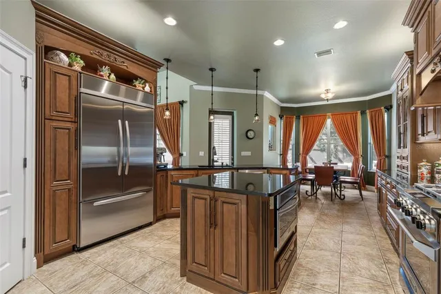 a kitchen with stainless steel appliances granite countertop a refrigerator and a sink
