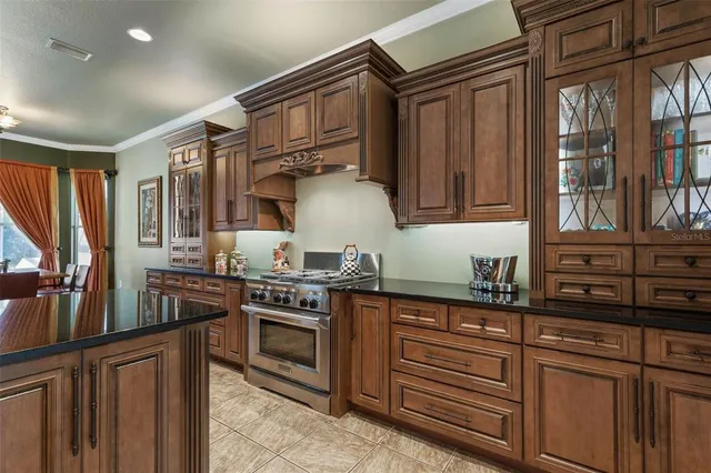 a kitchen with stainless steel appliances granite countertop a stove and cabinets