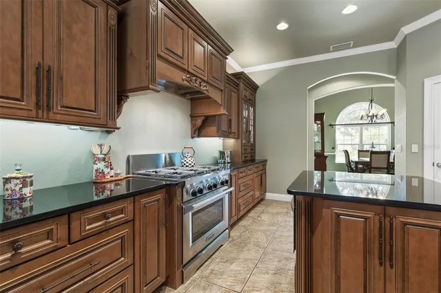 a kitchen with stainless steel appliances granite countertop a stove and a refrigerator