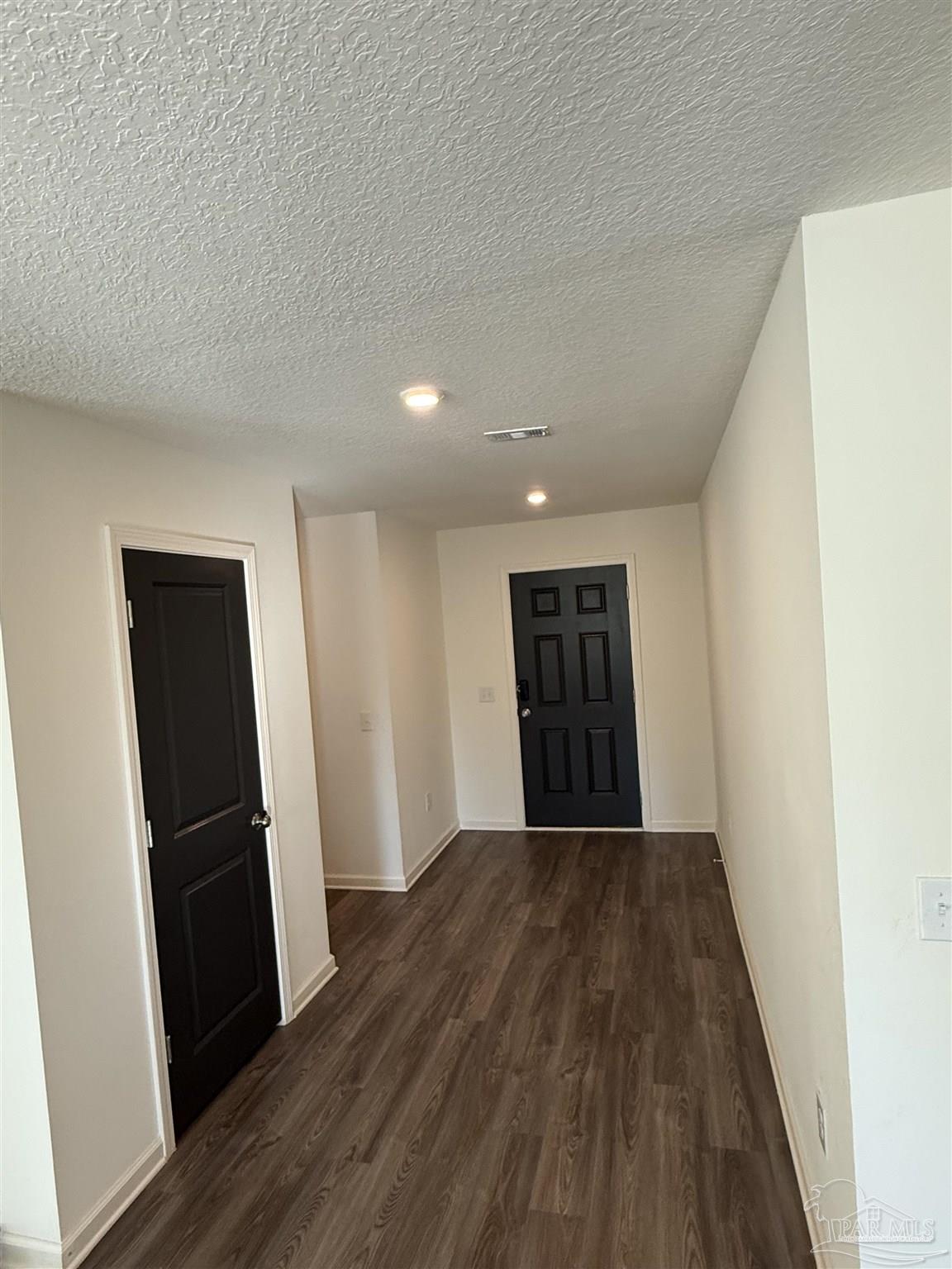 9279 3 Hollow Road Jay, FL 32565 - Photo 14 of 42 an empty room with wooden floor and entrance