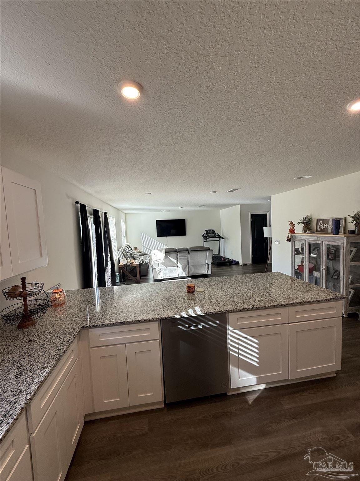 9279 3 Hollow Road Jay, FL 32565 - Photo 18 of 42 a large kitchen with granite countertop a sink and cabinets