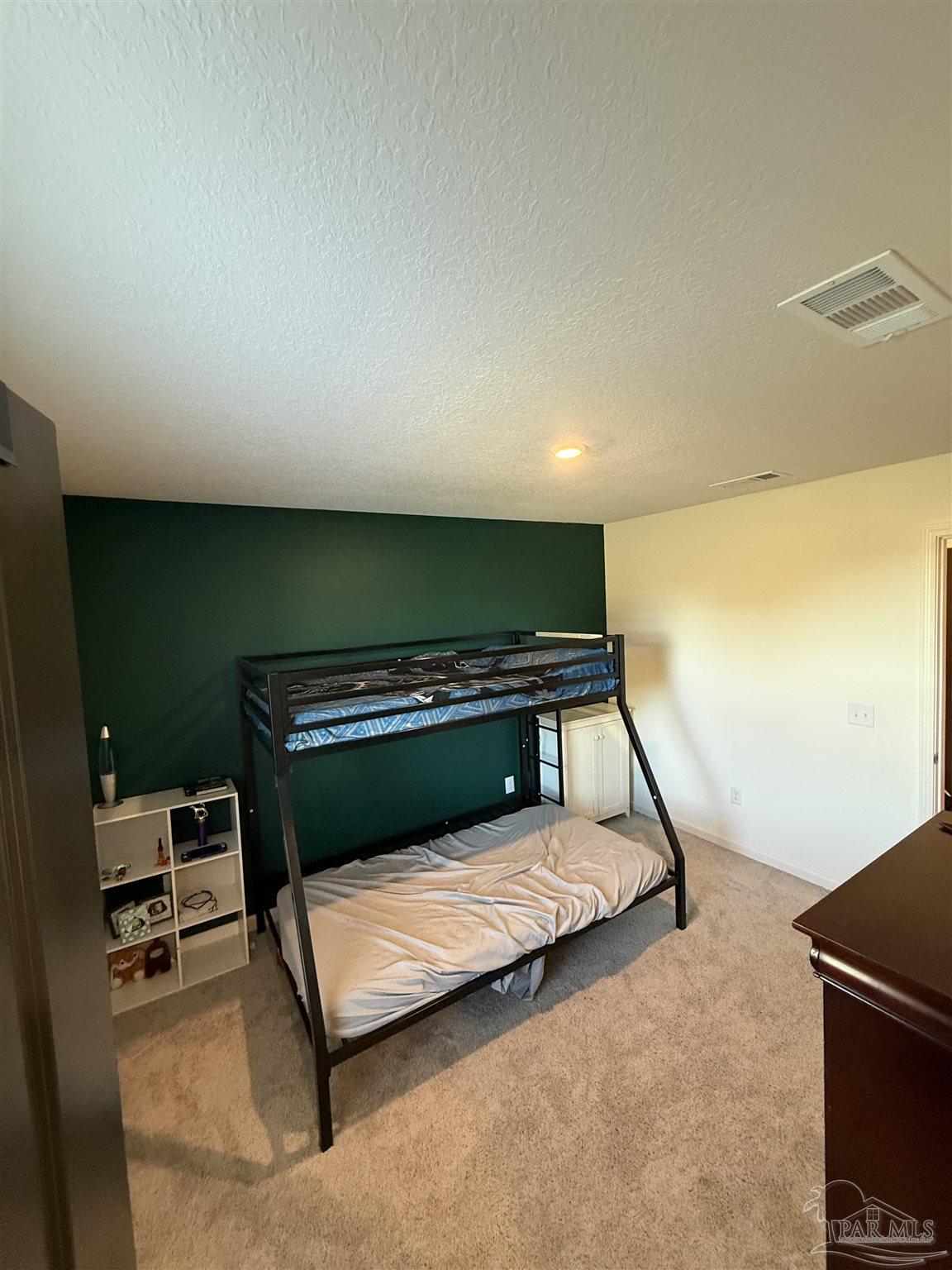 9279 3 Hollow Road Jay, FL 32565 - Photo 22 of 42 a bedroom with a bed and a night stand