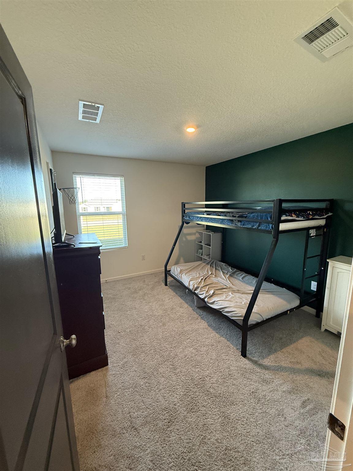 9279 3 Hollow Road Jay, FL 32565 - Photo 24 of 42 a living room with furniture gym equipment and a flat screen tv