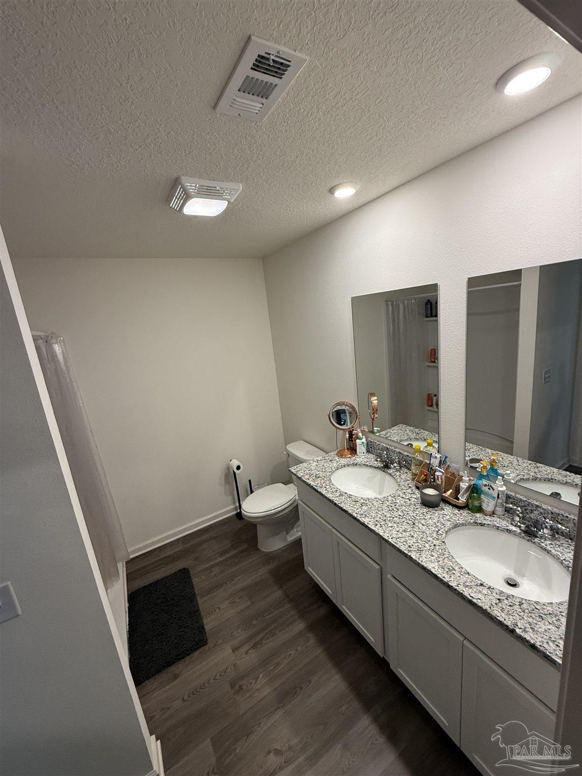 9279 3 Hollow Road Jay, FL 32565 - Photo 30 of 42 a bathroom with double vanity sink and mirror