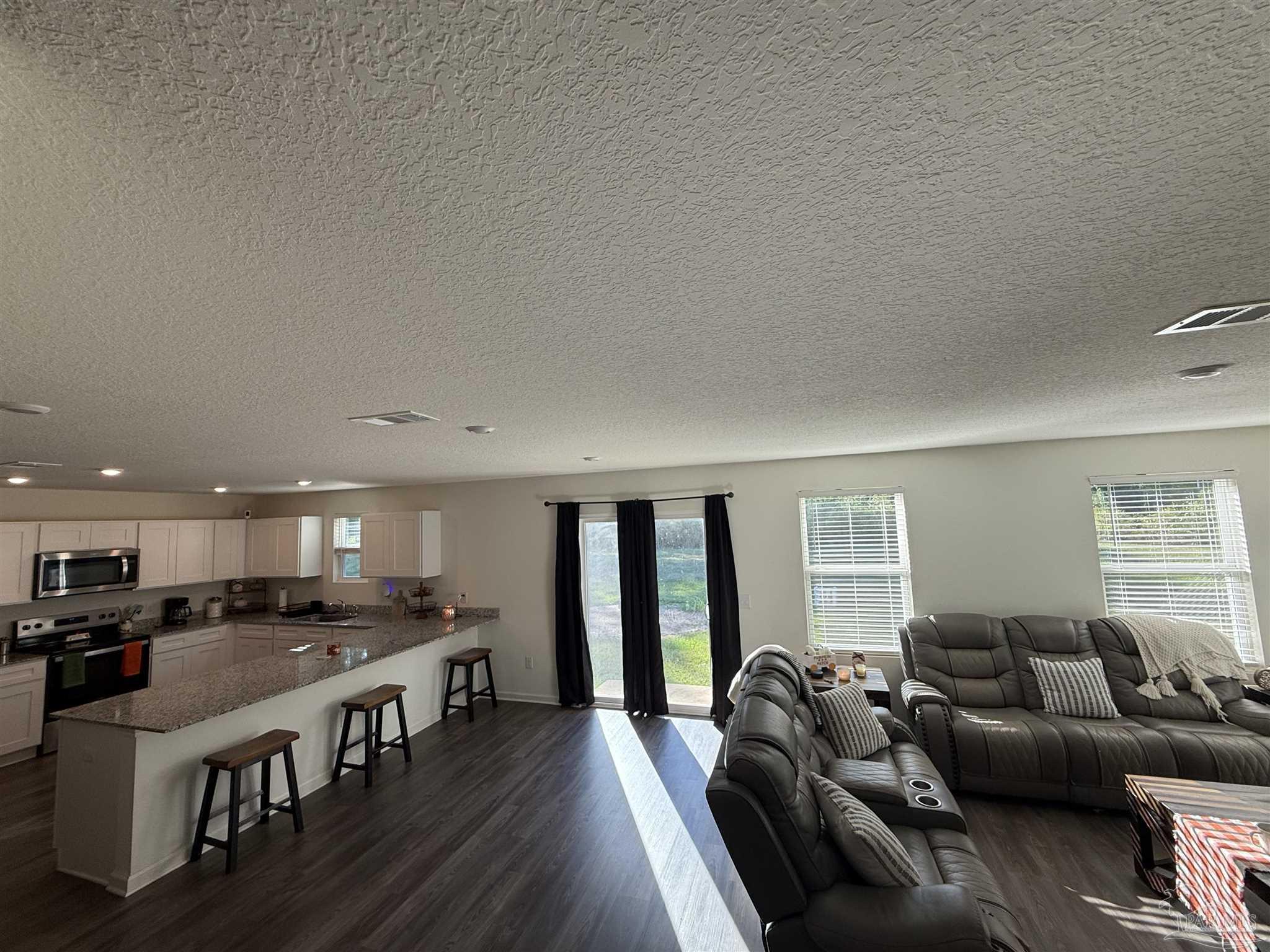 9279 3 Hollow Road Jay, FL 32565 - Photo 3 of 42 a living room with furniture and a wooden floor