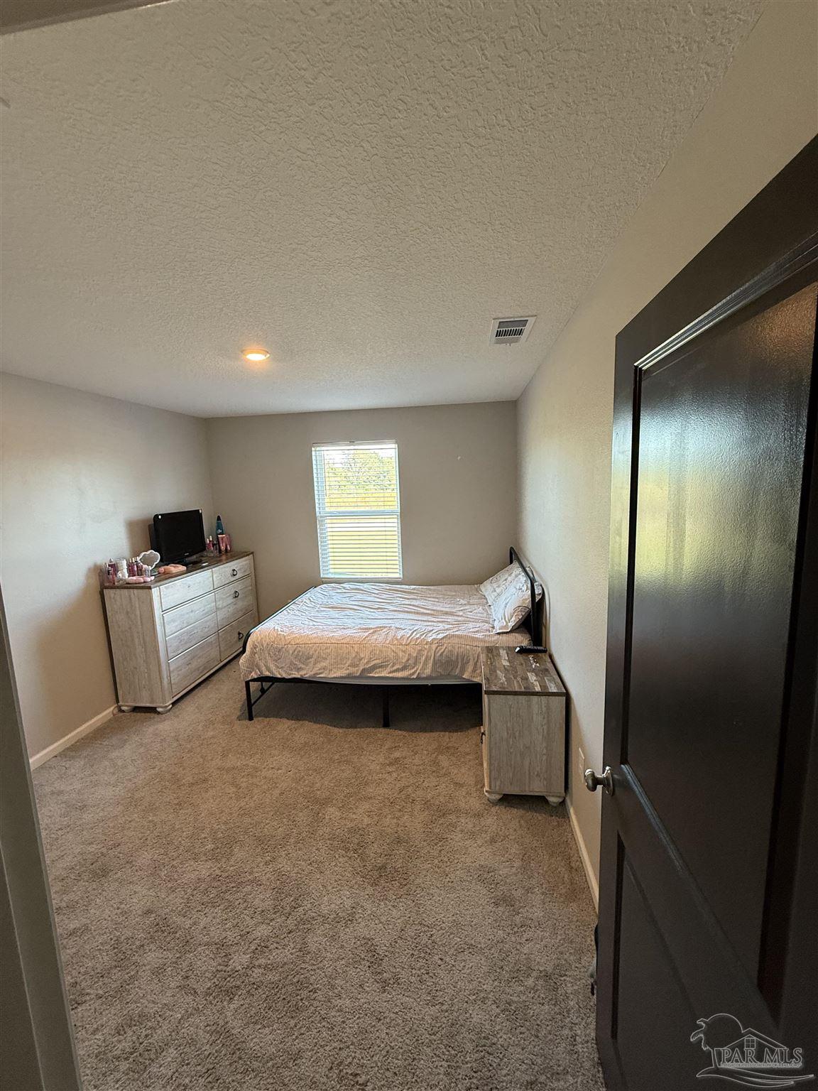 9279 3 Hollow Road Jay, FL 32565 - Photo 32 of 42 a room with a bed and a view of kitchen