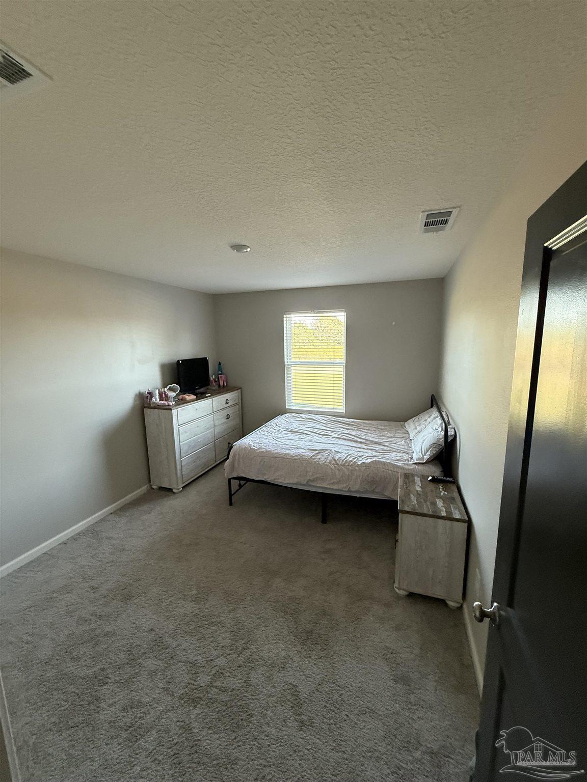 9279 3 Hollow Road Jay, FL 32565 - Photo 33 of 42 a bedroom with bed and window