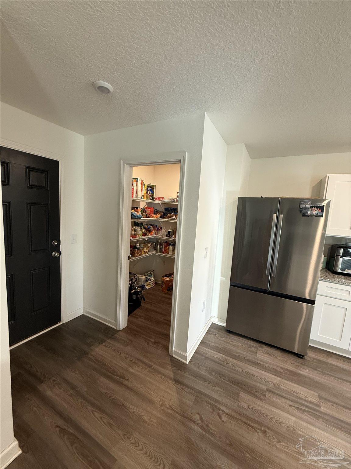 9279 3 Hollow Road Jay, FL 32565 - Photo 6 of 42 a view of a kitchen with wooden floor and a refrigerator