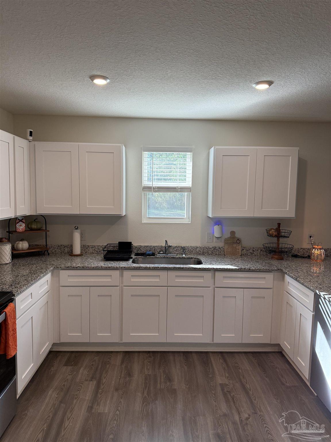 9279 3 Hollow Road Jay, FL 32565 - Photo 7 of 42 a kitchen with granite countertop a sink and cabinets