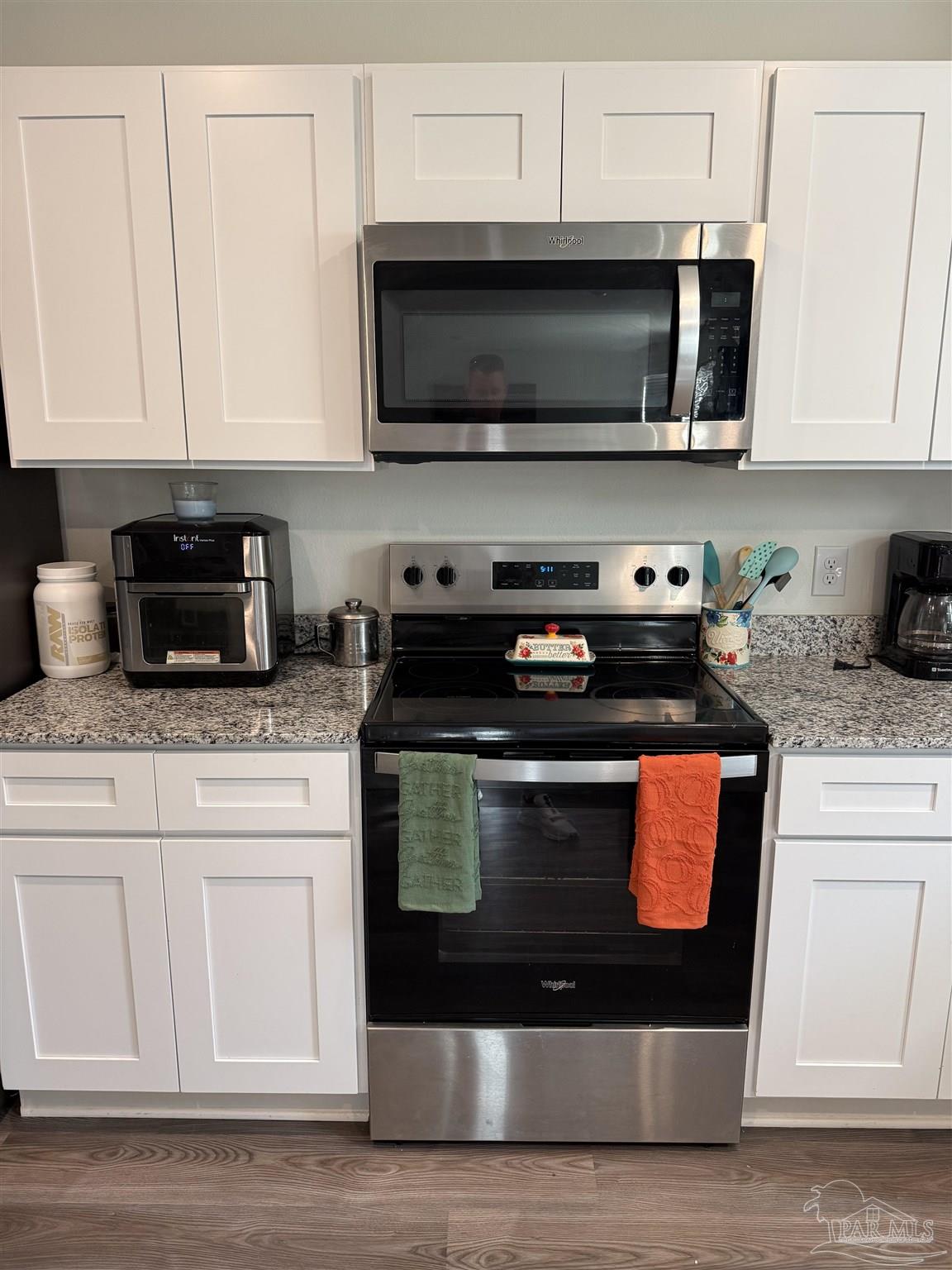 9279 3 Hollow Road Jay, FL 32565 - Photo 8 of 42 a kitchen with stainless steel appliances granite countertop a stove top oven microwave and cabinets