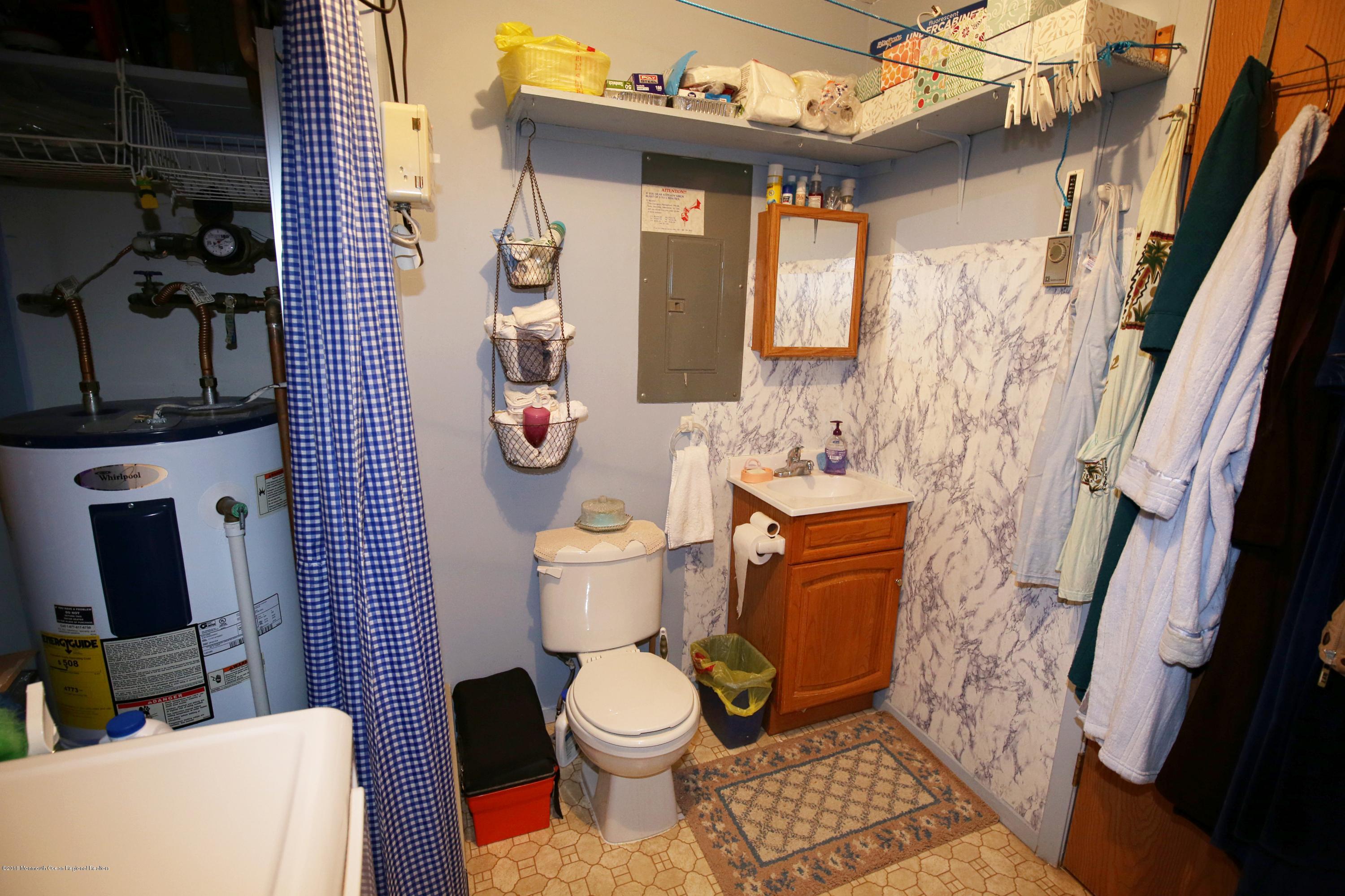 30A Mill Road, Unit C Whiting, NJ 08759 - Photo 19 of 23 a bathroom with a toilet sink and mirror