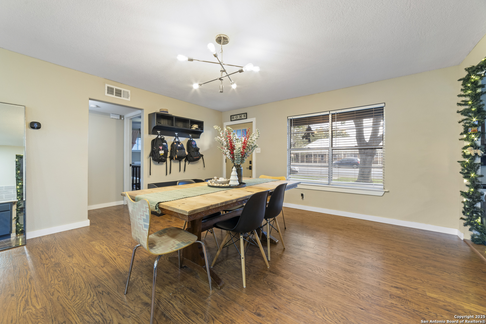 1706 24th Street Hondo, TX 78861 - Photo 12 of 40 a view of a dining room with furniture window and wooden floor