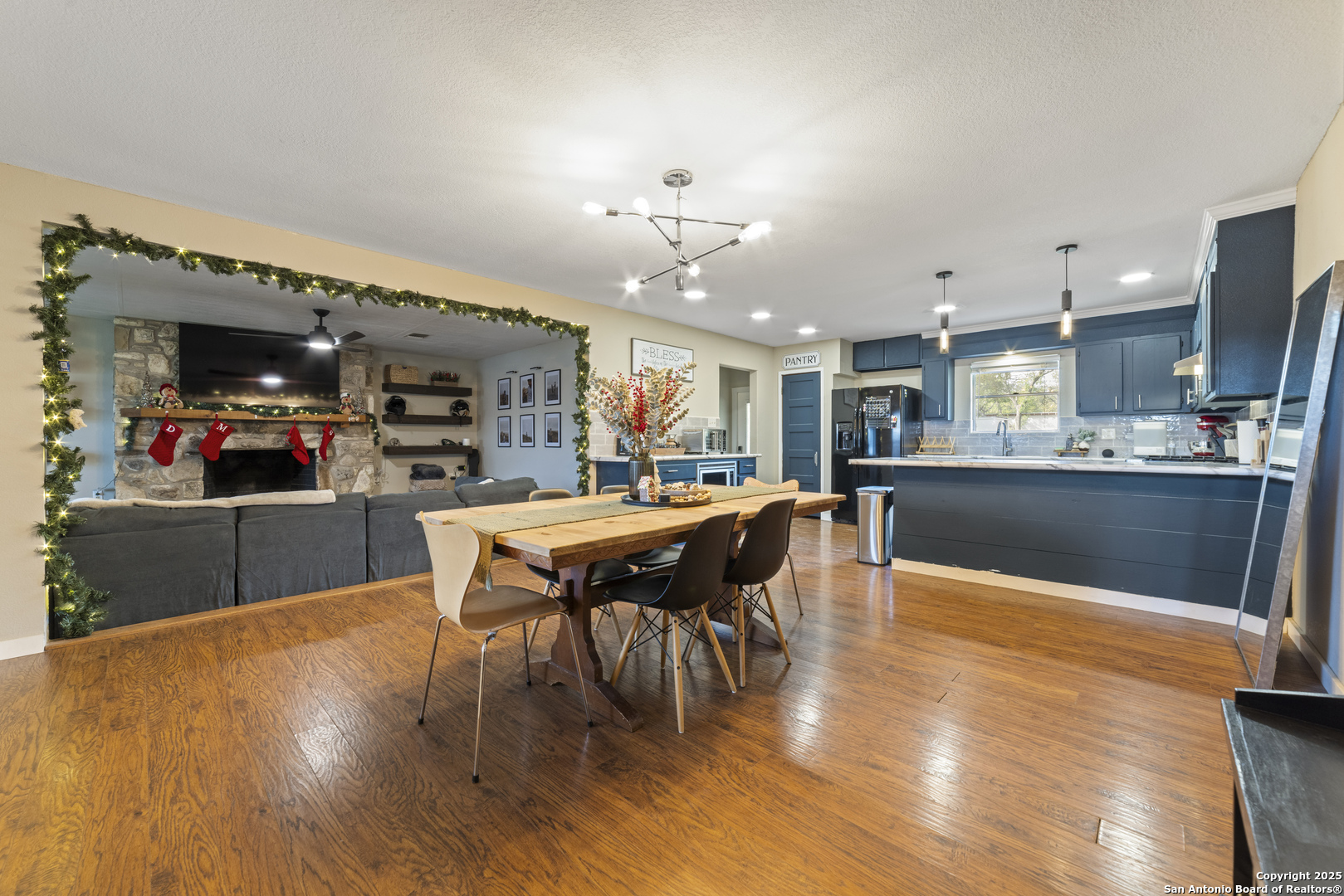 1706 24th Street Hondo, TX 78861 - Photo 13 of 40 a kitchen with stainless steel appliances kitchen island granite countertop a table chairs and a refrigerator