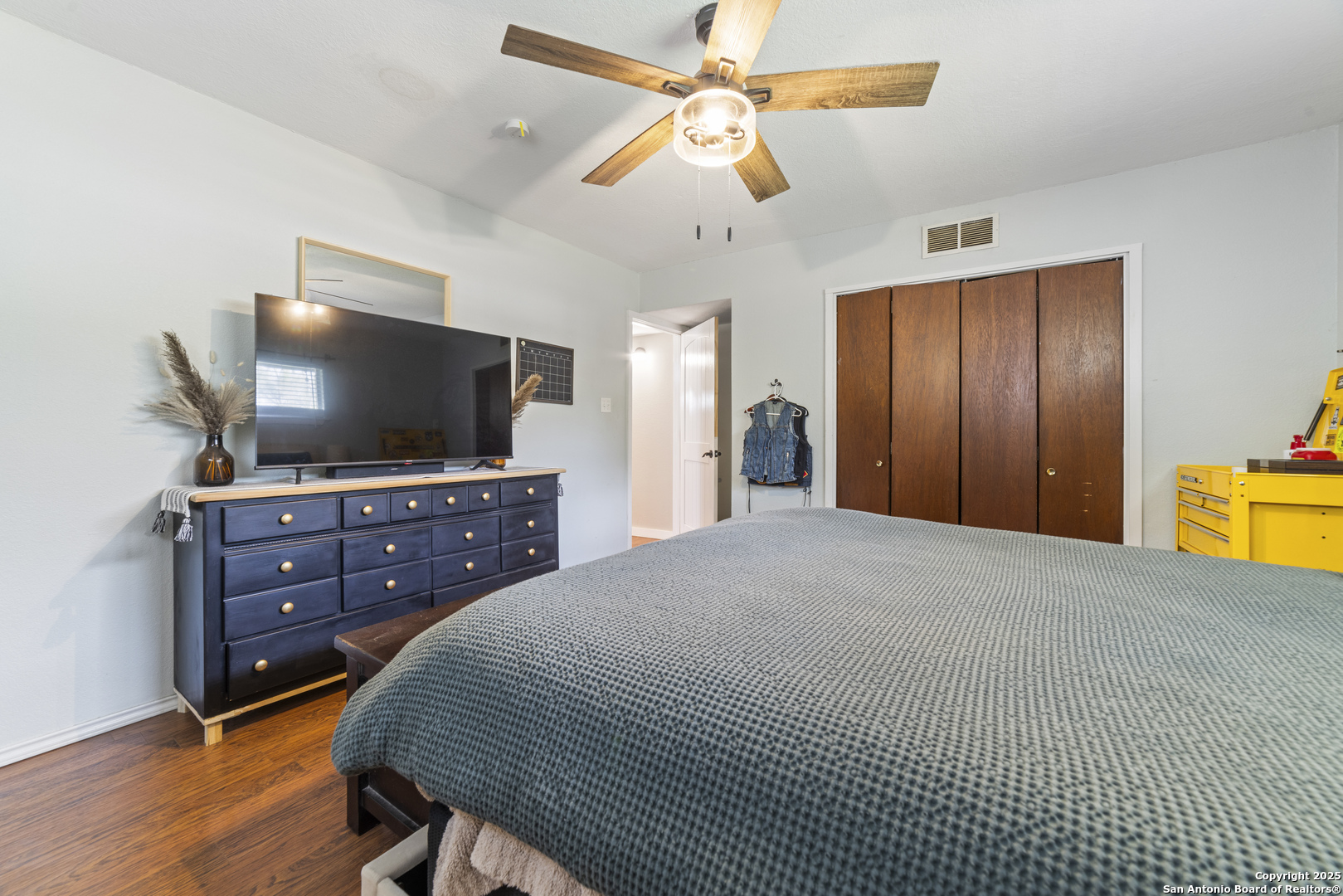 1706 24th Street Hondo, TX 78861 - Photo 19 of 40 a bedroom with a bed and a flat screen tv
