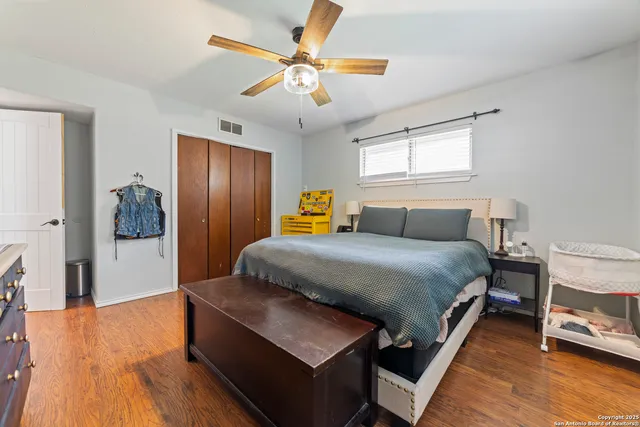 a bedroom with a bed and wooden floor