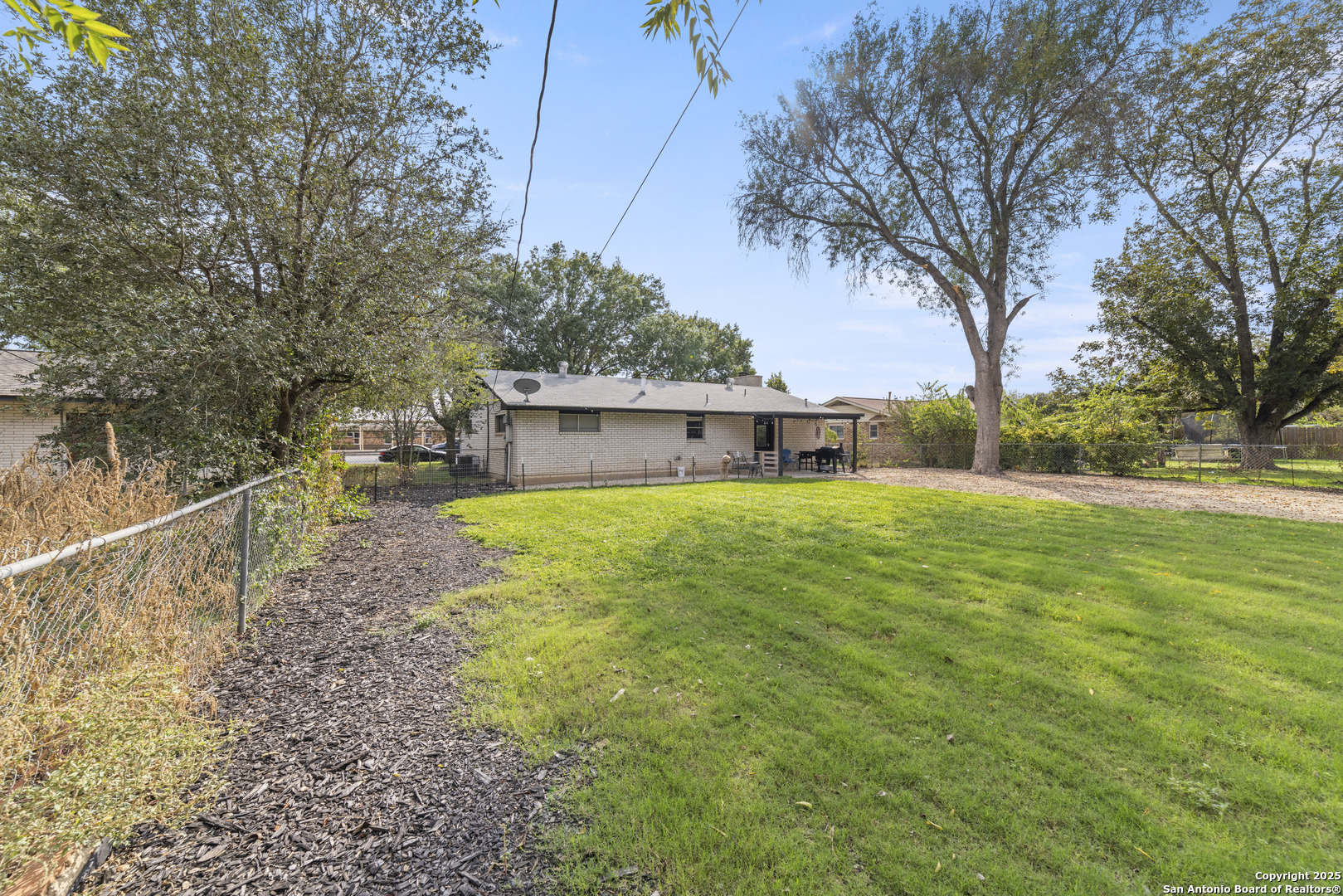 1706 24th Street Hondo, TX 78861 - Photo 29 of 40 a front view of house with yard and trees in the background