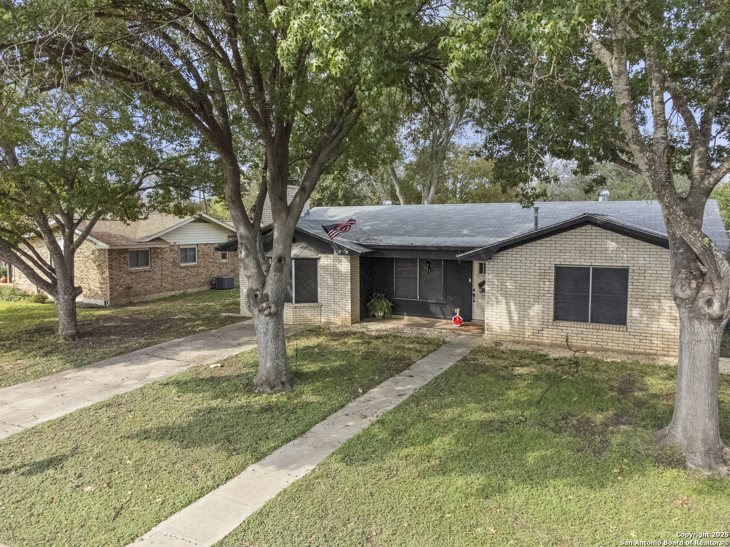 1706 24th Street Hondo, TX 78861 - Photo 3 of 40 a front view of a house with a yard