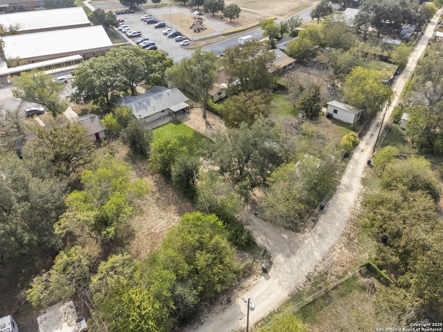 1706 24th Street Hondo, TX 78861 - Photo 35 of 40 a aerial view of a house with a yard and large trees