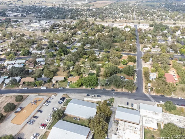 an aerial view of a house with yard