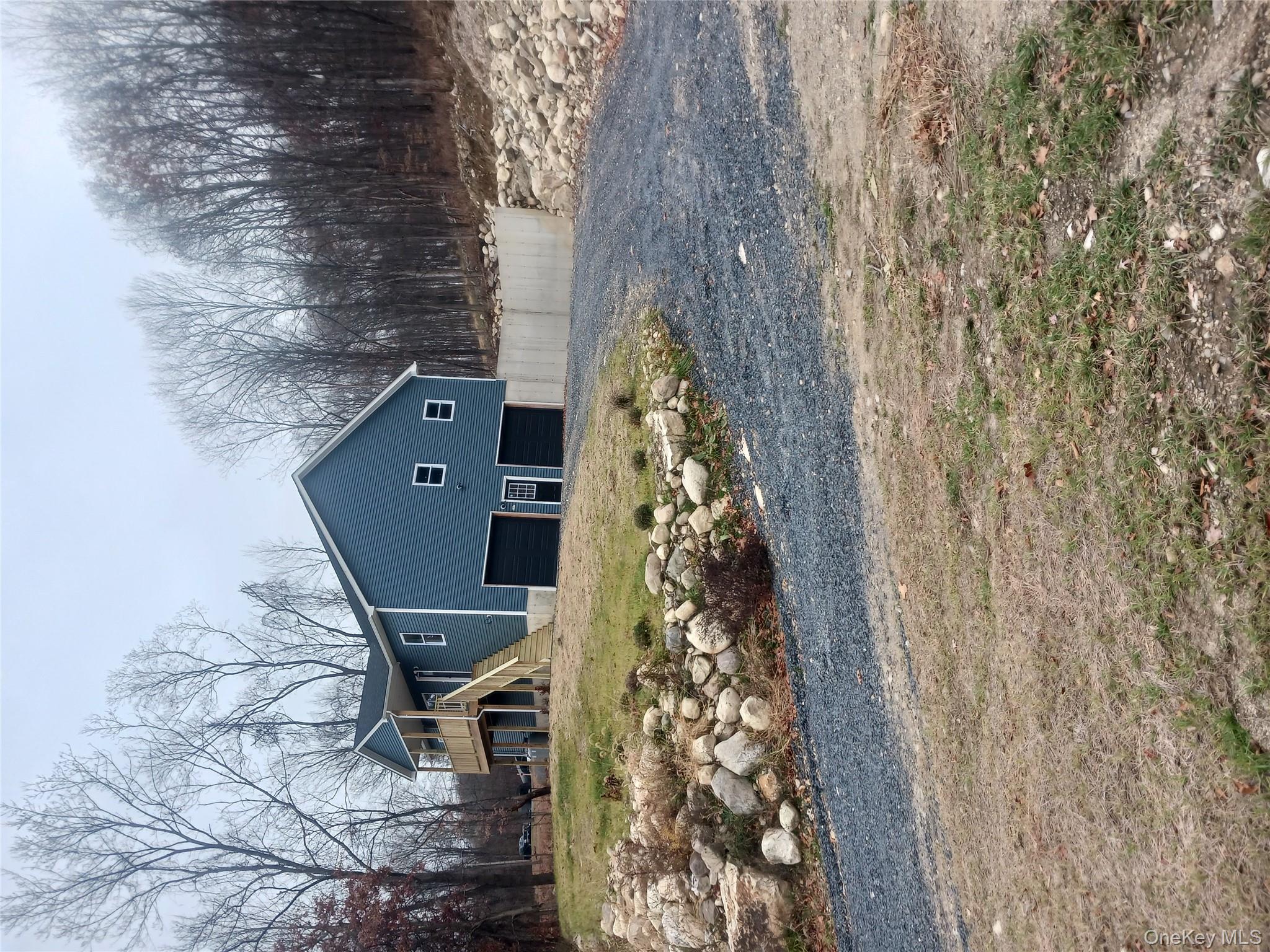 207 Roosa Gap Road Bloomingburg, NY 12721 - Photo 8 of 10 a front view of a house with a yard and garage