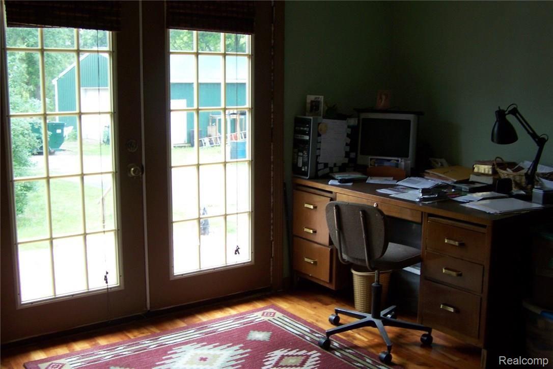 610 Young Road White Lake, MI 48383 - Photo 15 of 24 This office/bedroom has wood floors and a lake view. Large closet