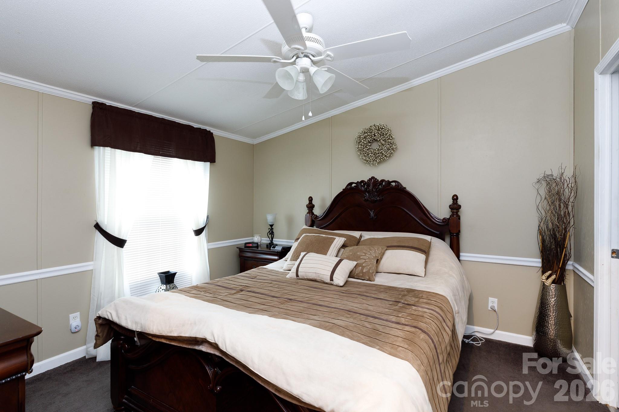 652 Sutton Spring Road York, SC 29745 - Photo 12 of 28 a bedroom with a bed and a painting on the wall