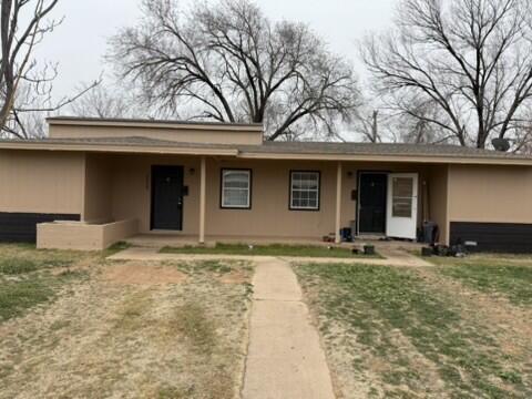 4609 Belton Avenue, Unit B Lubbock, TX 79413 - Photo 1 of 12 a front view of a house with garden and trees