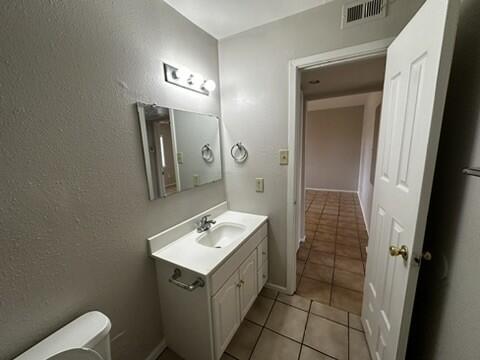 4609 Belton Avenue, Unit B Lubbock, TX 79413 - Photo 11 of 12 a bathroom with a sink a toilet and mirror