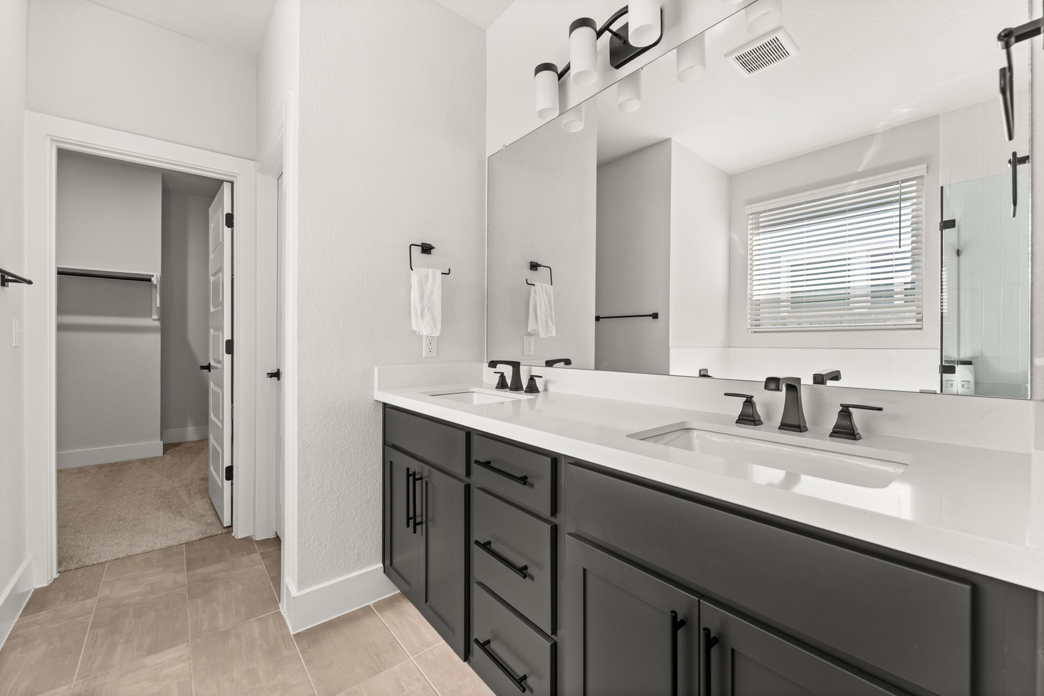 8512 McKamy Drive Austin, TX 78744 - Photo 15 of 28 Quartz dual vanities bring style and functionality to the primary bath.