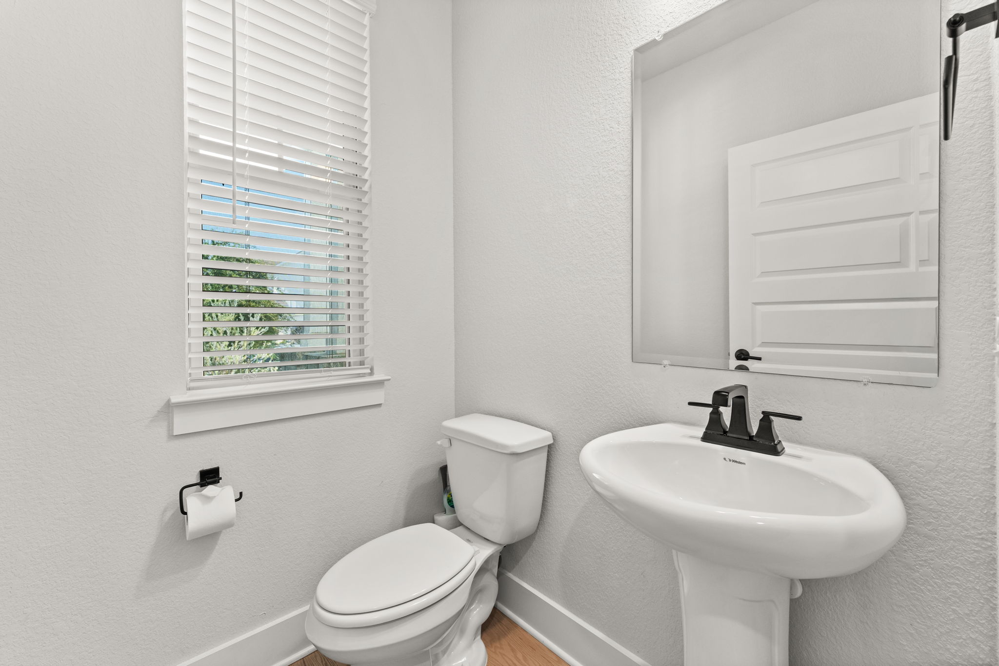 8512 McKamy Drive Austin, TX 78744 - Photo 17 of 28 The conveniently located half bath features stylish finishes and modern design.