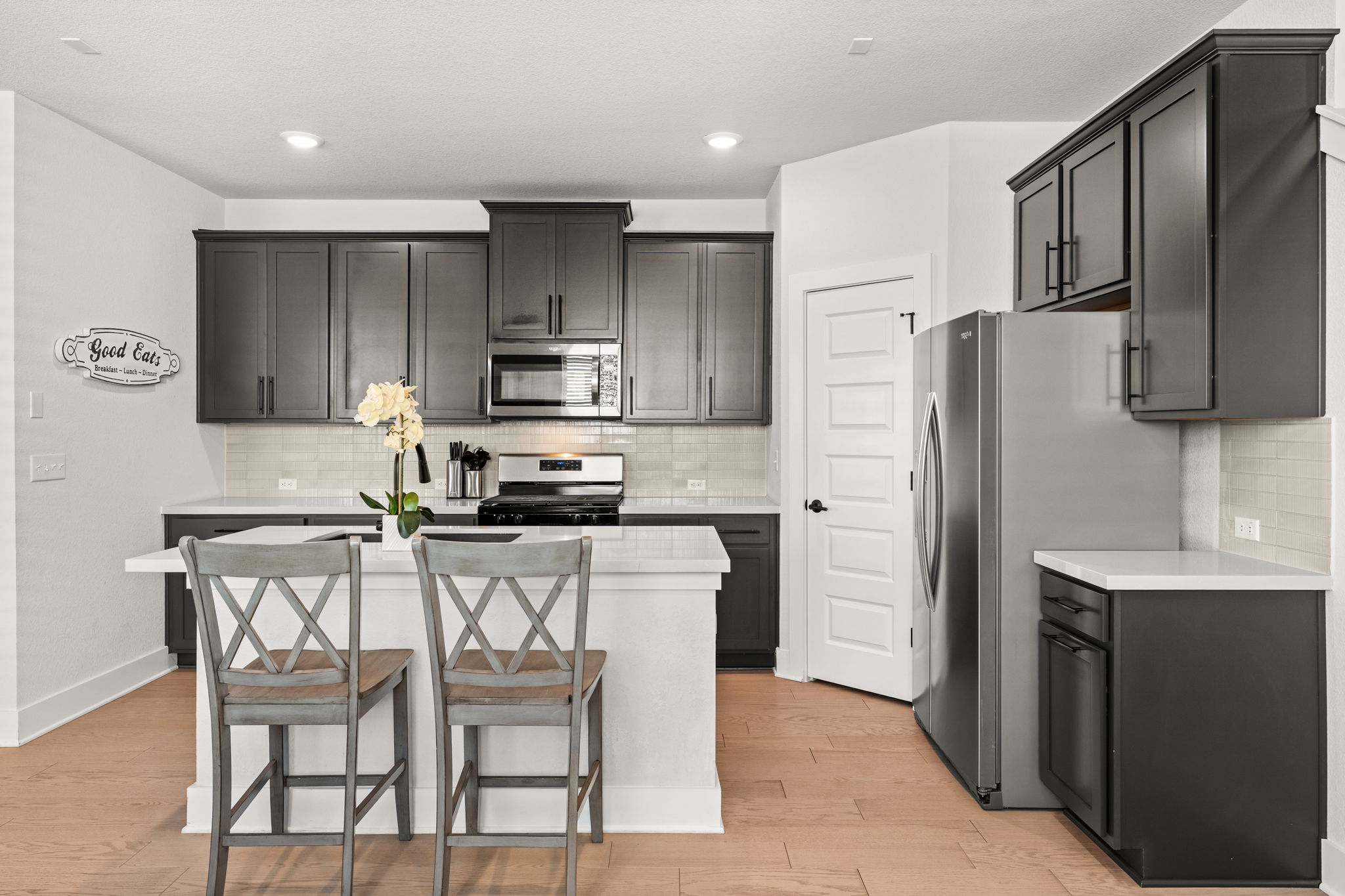 8512 McKamy Drive Austin, TX 78744 - Photo 6 of 28 The gourmet kitchen features quartz countertops and a large center island.