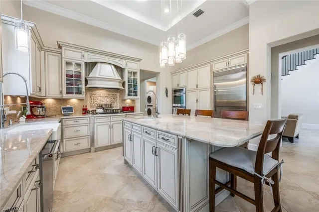 a kitchen with granite countertop a table chairs stove and cabinets