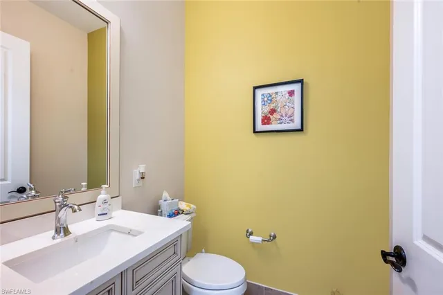 a bathroom with a sink mirror and toilet