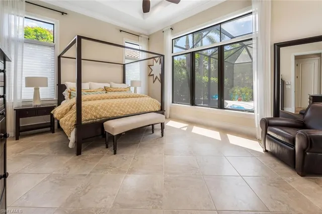 a spacious bedroom with a bed and a large window