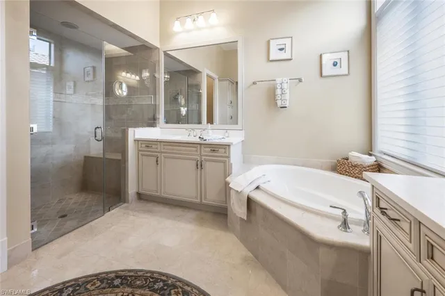 a bathroom with a tub sink and mirror