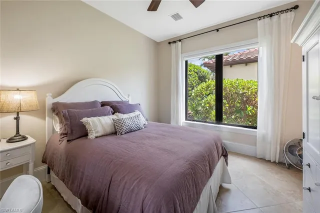 a bed sitting in a bedroom next to a window