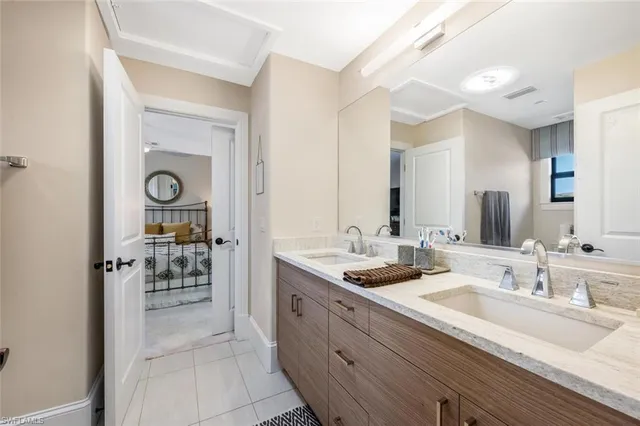 a spacious bathroom with a granite countertop sink a mirror and a shower